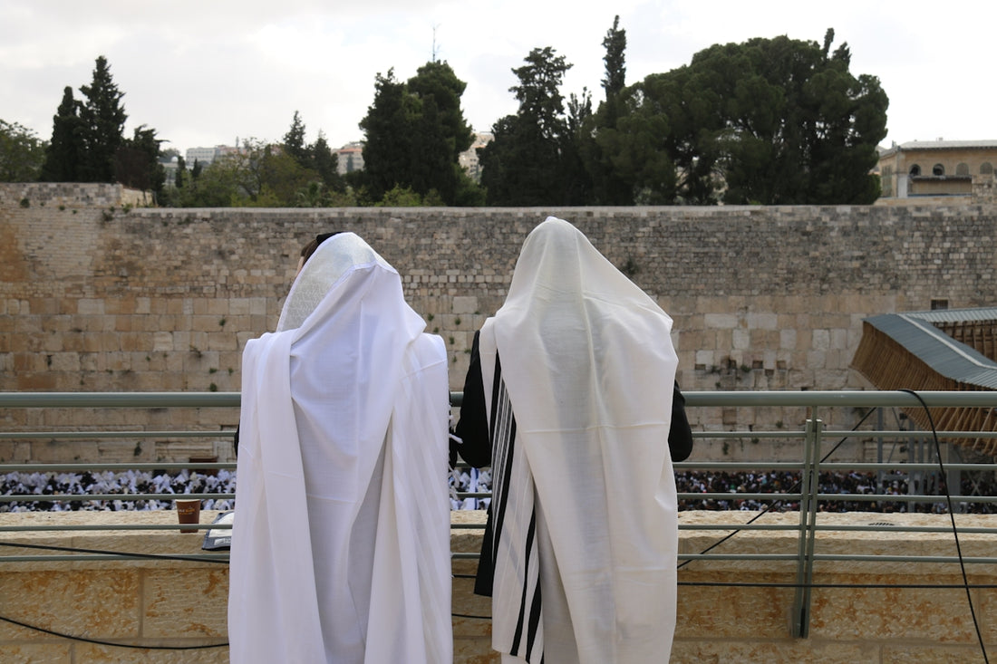 two men dressed in white standing next to each other